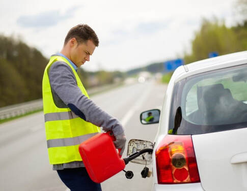 Roadside technician filling car with gas